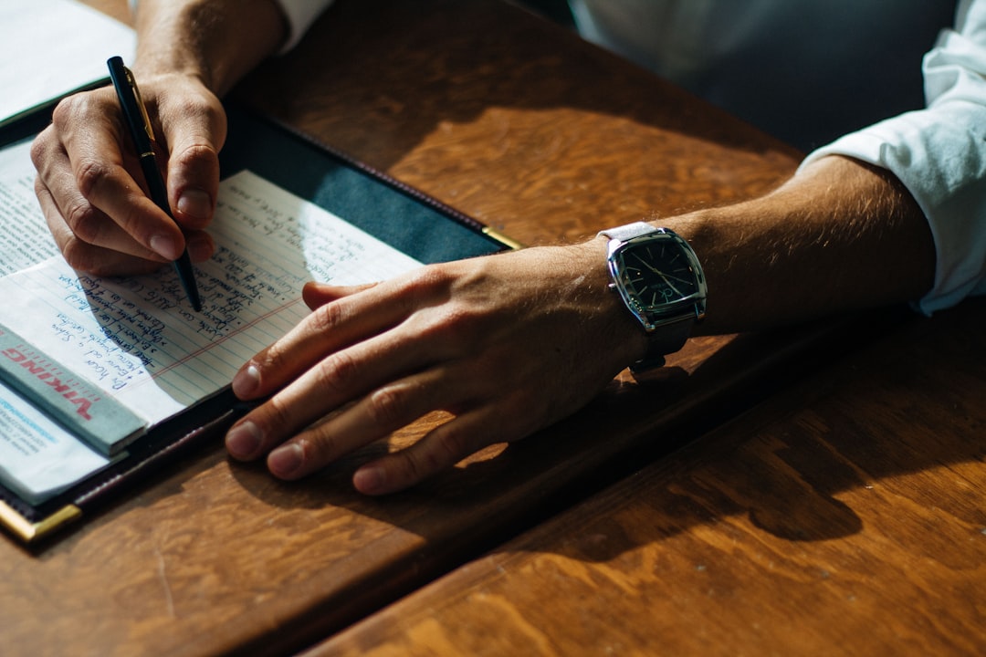data licensing — person writing on paper leaning on brown table