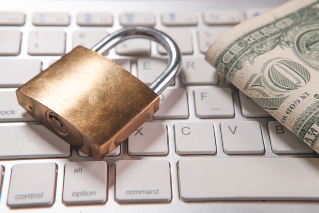 origination moment — A padlock and dollar bills rest on a computer keyboard.