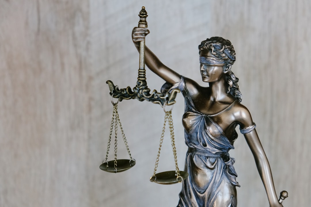 trademark law copyright — woman holding sword statue during daytime